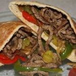 A close up of a FALAFEL sandwich on a plate